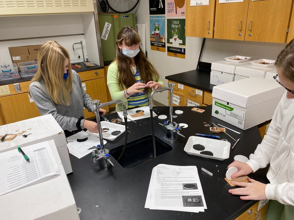 Students building prototype cars.
